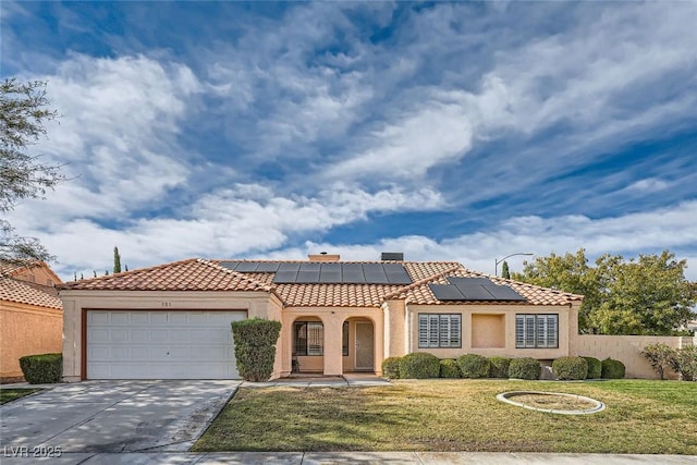 mediterranean / spanish home featuring a front yard, a garage, and solar panels