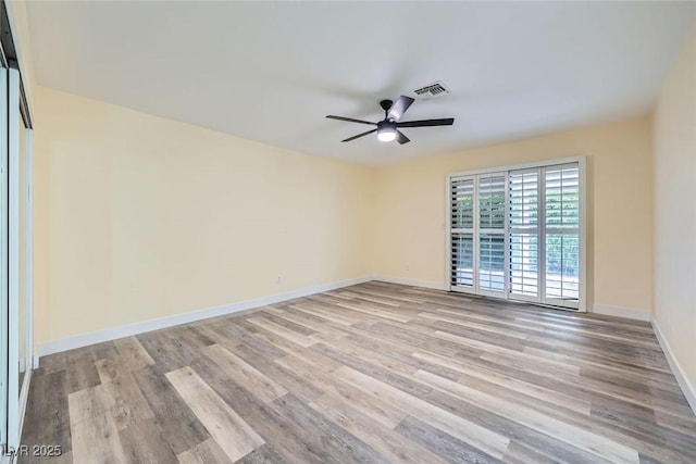 empty room featuring ceiling fan and light hardwood / wood-style flooring