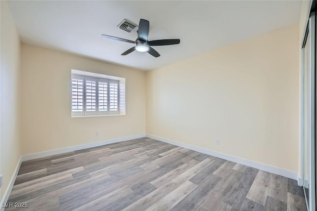 spare room featuring ceiling fan and light hardwood / wood-style floors