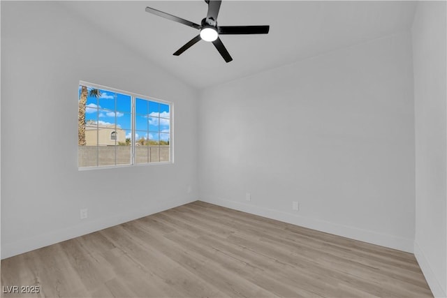 spare room featuring ceiling fan, light wood-type flooring, and lofted ceiling