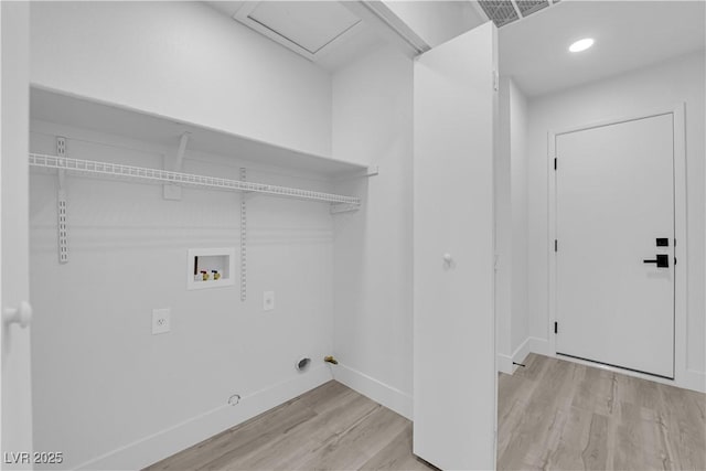 laundry area with gas dryer hookup, hookup for a washing machine, and light hardwood / wood-style flooring