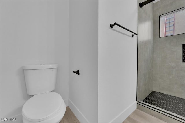 bathroom featuring toilet and tiled shower