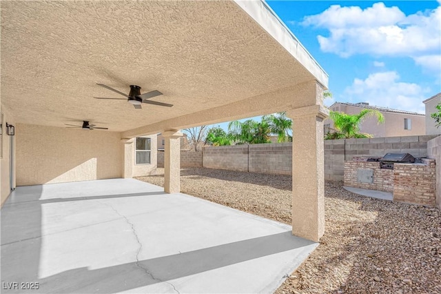 view of patio featuring ceiling fan, a grill, and exterior kitchen