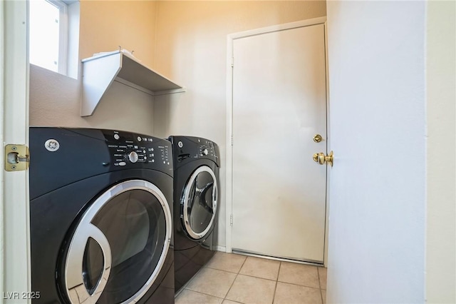 laundry room featuring light tile patterned floors and washing machine and dryer