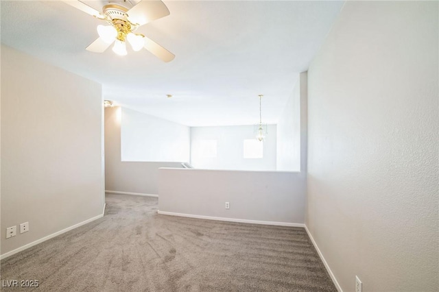 empty room featuring ceiling fan and carpet flooring