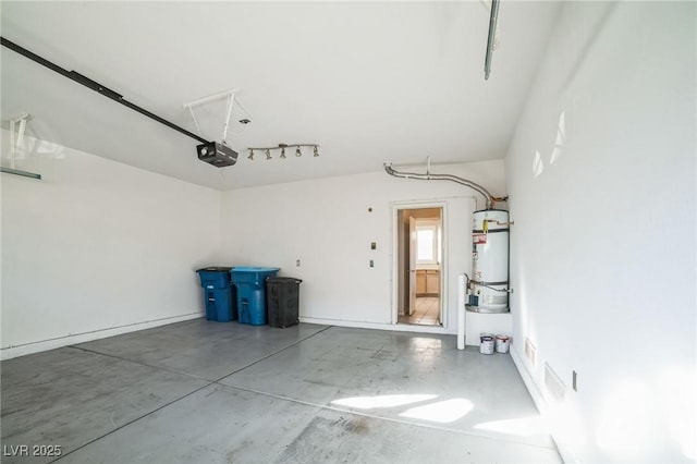 garage with strapped water heater and a garage door opener