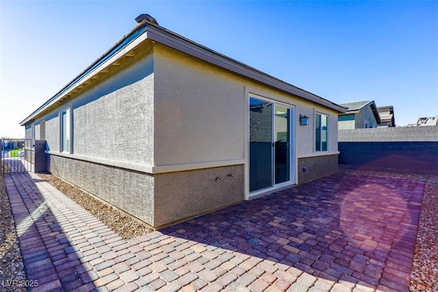 view of side of home with a patio