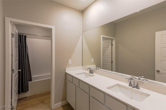 bathroom featuring vanity, shower / bath combination with curtain, and hardwood / wood-style flooring