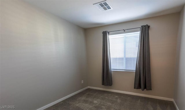 empty room featuring dark colored carpet