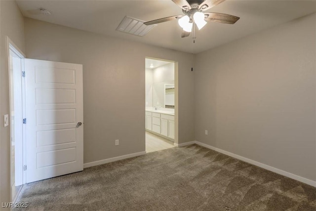 spare room featuring light carpet and ceiling fan