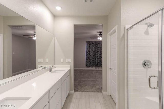 bathroom with an enclosed shower and vanity