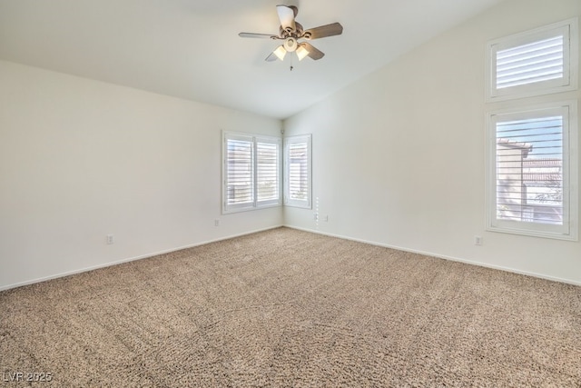 empty room with lofted ceiling, carpet floors, and ceiling fan