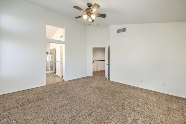 carpeted spare room with high vaulted ceiling and ceiling fan