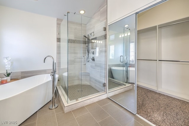 bathroom featuring tile patterned floors and independent shower and bath