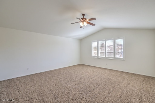 unfurnished room with vaulted ceiling, carpet flooring, and a ceiling fan