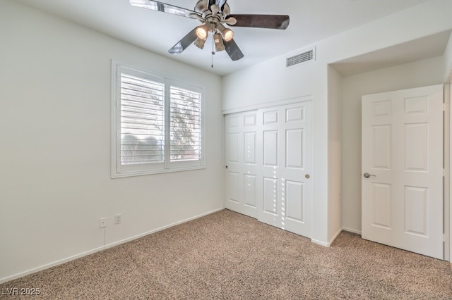 unfurnished bedroom with light carpet, ceiling fan, and a closet