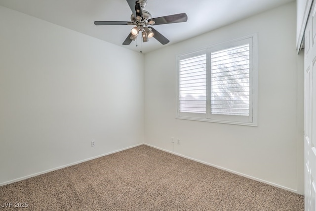 carpeted empty room featuring ceiling fan and baseboards