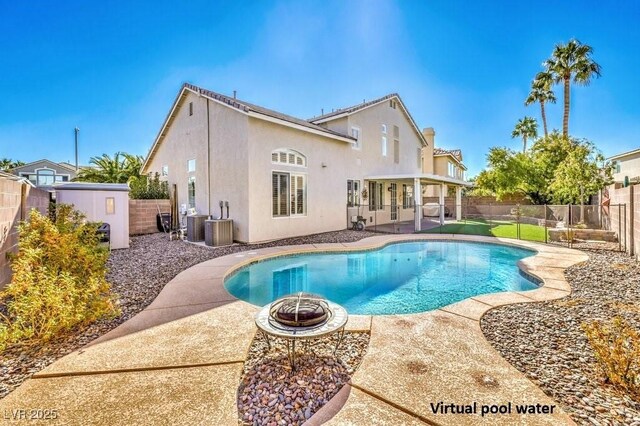 view of pool featuring a storage shed, central AC unit, a patio area, and an outdoor fire pit