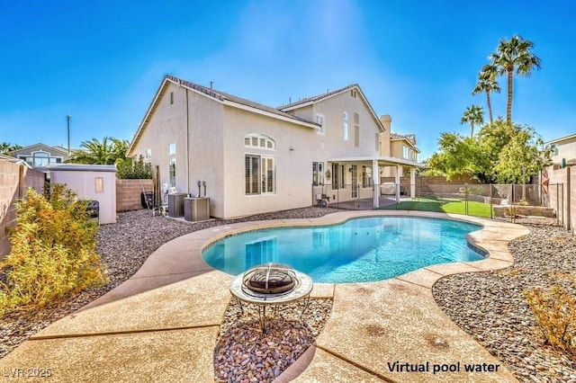 back of property with a fire pit, a patio area, a fenced backyard, and stucco siding