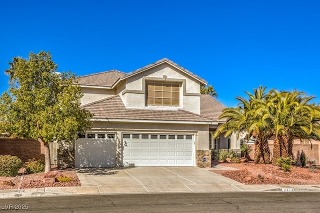 view of front of house featuring a tile roof, concrete driveway, and stucco siding