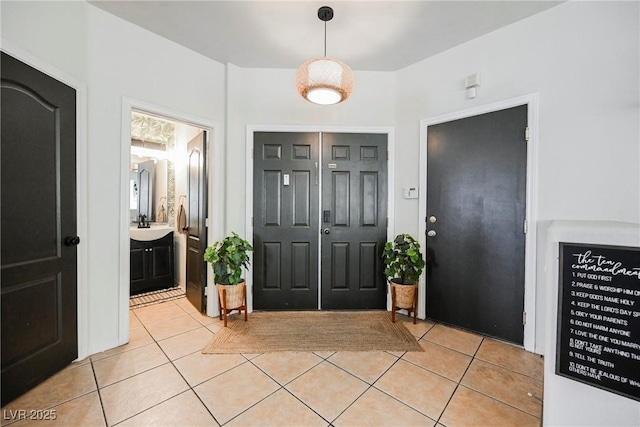 tiled entryway featuring sink