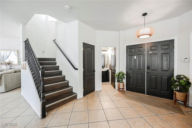 foyer entrance with light tile patterned floors