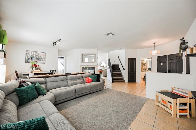 tiled living room featuring track lighting