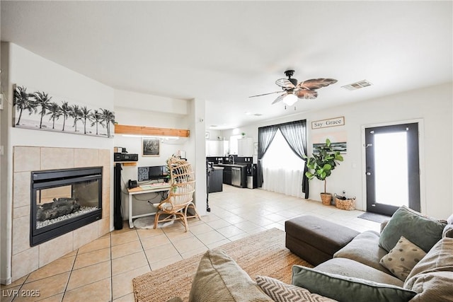 living room with ceiling fan, light tile patterned floors, and a fireplace