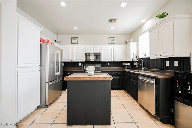 kitchen featuring white cabinets, stainless steel appliances, and a kitchen island