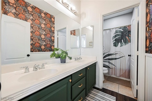 bathroom featuring toilet, hardwood / wood-style floors, and vanity