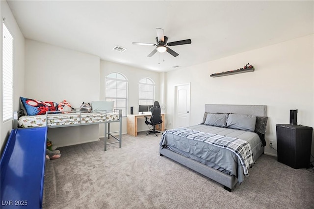 bedroom with ceiling fan, multiple windows, and carpet flooring