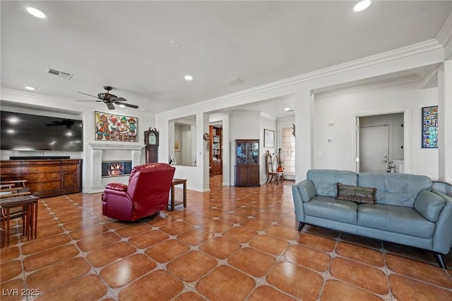 living room featuring ceiling fan and ornamental molding