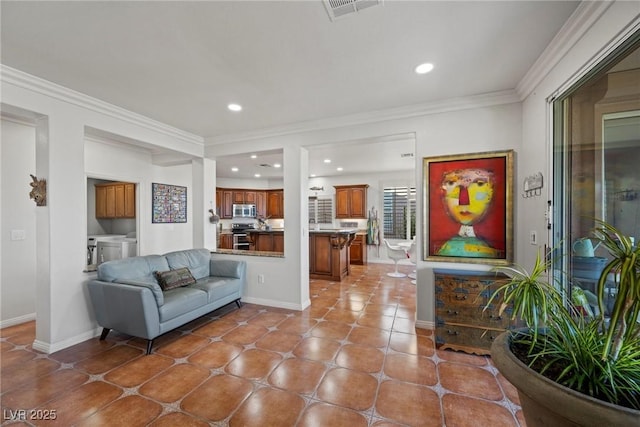 living room featuring ornamental molding and washing machine and dryer