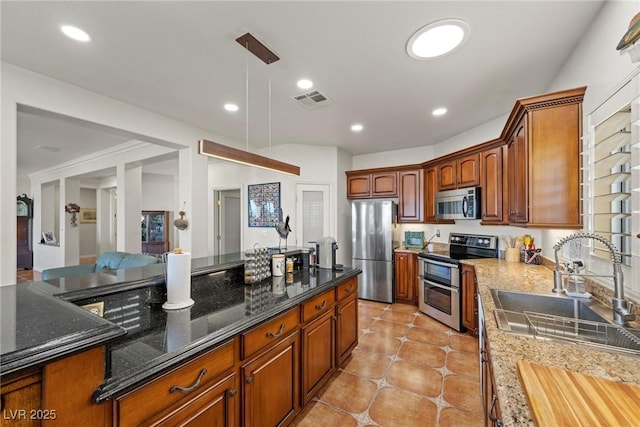 kitchen featuring pendant lighting, appliances with stainless steel finishes, dark stone counters, sink, and light tile patterned floors