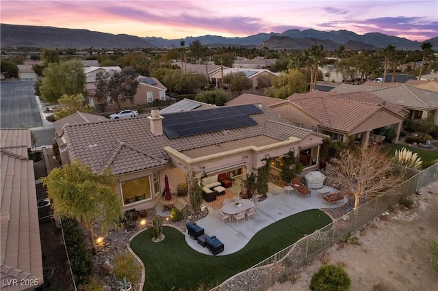 aerial view at dusk featuring a mountain view