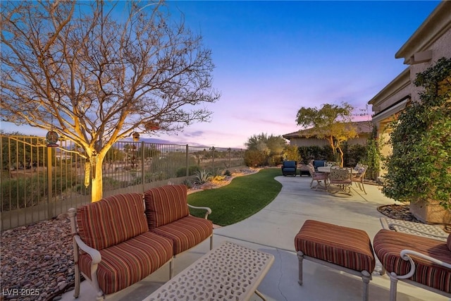 patio terrace at dusk featuring an outdoor living space