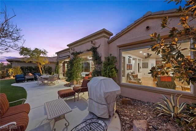 patio terrace at dusk with a grill