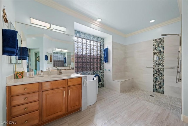 bathroom featuring vanity, ornamental molding, and shower with separate bathtub