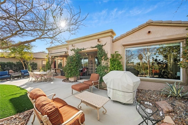 rear view of house featuring an outdoor living space and a patio