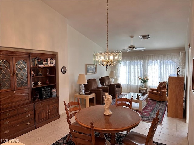 tiled dining space featuring vaulted ceiling and ceiling fan with notable chandelier