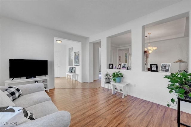 living room featuring hardwood / wood-style flooring and a notable chandelier