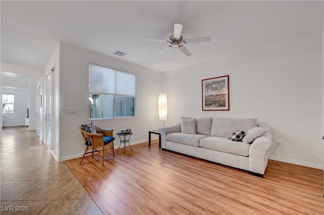 tiled living room featuring ceiling fan