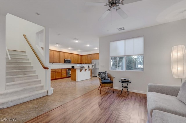 tiled living room featuring ceiling fan