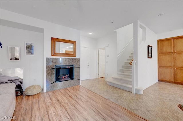 unfurnished living room featuring light tile patterned floors and a fireplace