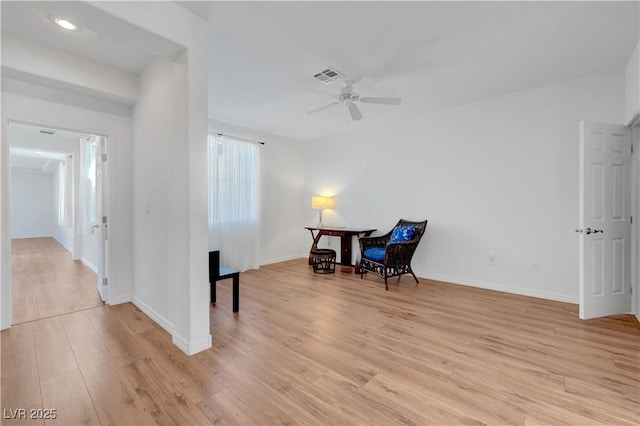 living area featuring ceiling fan and light wood-type flooring