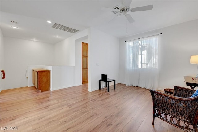 sitting room featuring ceiling fan and light wood-type flooring