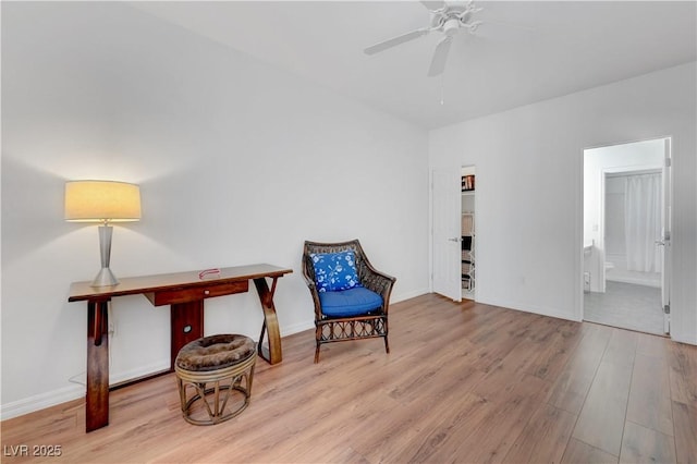 living area featuring ceiling fan and light wood-type flooring