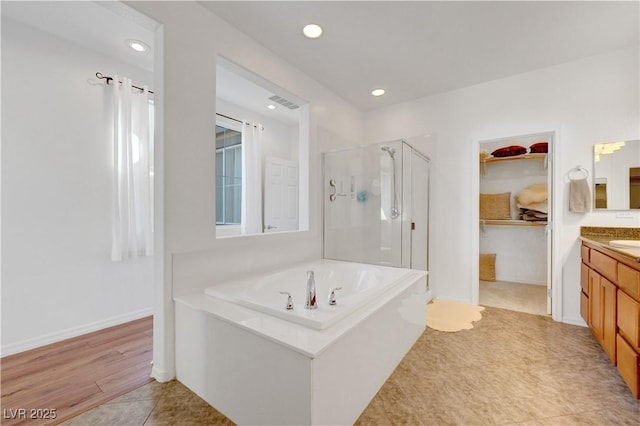 bathroom featuring separate shower and tub, vanity, and tile patterned floors