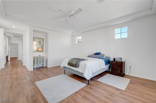 bedroom with ceiling fan and light hardwood / wood-style flooring