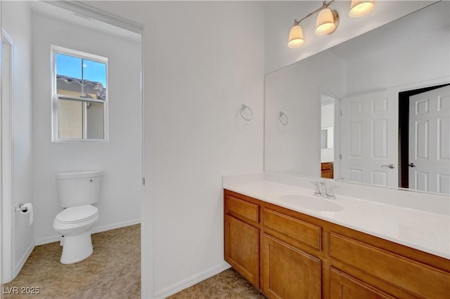 bathroom featuring toilet and vanity